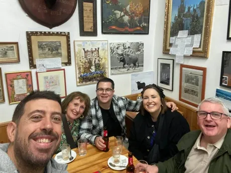 Small group enjoying tapas in a local Seville bar